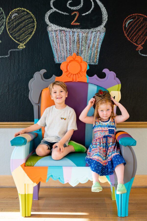 Two children sitting in the Museum's Birthday Throne!